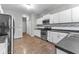 Updated kitchen featuring stainless steel appliances, white cabinetry, and tile backsplash at 1820 E Maryland St, Indianapolis, IN 46201