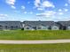 An aerial view of the modern home showing a well-maintained lawn, a backyard patio, and gray siding at 19568 Astoria Ave, Sheridan, IN 46069