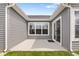 Concrete back patio showing gray siding, sliding glass door, and a small grassy area at 19568 Astoria Ave, Sheridan, IN 46069