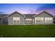 Spacious backyard with a lush green lawn, complemented by gray siding and windows at 19568 Astoria Ave, Sheridan, IN 46069
