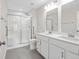 Modern bathroom with a double vanity, a large shower with glass doors, and ample lighting at 19568 Astoria Ave, Sheridan, IN 46069