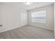 Clean bedroom with a window, neutral carpet, and double door closet provides a calm, adaptable living space at 19568 Astoria Ave, Sheridan, IN 46069