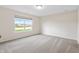 Bright bedroom with a large window bringing in natural light, carpeted floor, and neutral walls at 19568 Astoria Ave, Sheridan, IN 46069