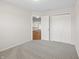 A roomy, carpeted bedroom showcases neutral walls and an open door with a peek into the adjacent living space at 19568 Astoria Ave, Sheridan, IN 46069