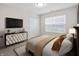 Comfortable bedroom featuring stylish decor, a large window, and a sleek cabinet for organized living at 19568 Astoria Ave, Sheridan, IN 46069