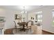 Well-lit dining area leading to the cozy living room offering an open-concept layout, ideal for entertaining at 19568 Astoria Ave, Sheridan, IN 46069