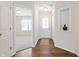 Bright entryway with wood flooring, a white door, and an open view to the living area at 19568 Astoria Ave, Sheridan, IN 46069