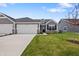 Inviting new construction home with a two-car garage, stone accents and nice lawn at 19568 Astoria Ave, Sheridan, IN 46069