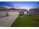 Charming home featuring a white garage door, well-kept lawn, and stone accents at 19568 Astoria Ave, Sheridan, IN 46069