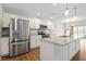 Bright kitchen featuring white cabinets, an island, and stainless steel appliances at 19568 Astoria Ave, Sheridan, IN 46069