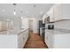 Well-lit kitchen with white cabinets, a granite countertop, and stainless steel appliances at 19568 Astoria Ave, Sheridan, IN 46069