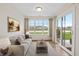Inviting living room with large windows, slider door and a serene view at 19568 Astoria Ave, Sheridan, IN 46069