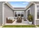 Cozy patio with wicker furniture, surrounded by gray siding and bright windows at 19568 Astoria Ave, Sheridan, IN 46069