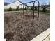 Community swings with pea gravel ground cover, framed by trees and nearby homes at 19568 Astoria Ave, Sheridan, IN 46069