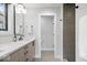 Modern bathroom features a sleek vanity, large mirror, and a separate shower area with stylish tile work at 2026 Alvord St, Indianapolis, IN 46202