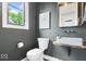 Chic powder room featuring a unique stone sink, stylish faucet, toilet and contemporary design elements at 2026 Alvord St, Indianapolis, IN 46202
