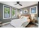 Cozy bedroom with three bright windows, bedside tables, and a comfortable bed with decorative pillows at 2026 Alvord St, Indianapolis, IN 46202