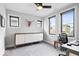 Bright bedroom with a ceiling fan, three windows providing natural light, and a modern cabinet at 2026 Alvord St, Indianapolis, IN 46202
