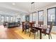 Open floorplan showcases a dining area with a modern chandelier and view to living room fireplace at 2026 Alvord St, Indianapolis, IN 46202