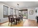 Bright dining area with modern lighting, adjacent sliding glass doors to the back deck, and hard wood flooring at 2026 Alvord St, Indianapolis, IN 46202