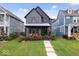 Charming two-story home with a well-manicured lawn, covered porch, and patriotic American flag at 2026 Alvord St, Indianapolis, IN 46202