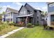 Charming two-story home with modern gray siding, landscaped front yard, and inviting front porch with an American flag at 2026 Alvord St, Indianapolis, IN 46202
