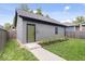 Detached one car garage with a green door and walkway through backyard grass at 2026 Alvord St, Indianapolis, IN 46202