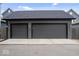 Two car detached garage with concrete driveway and gray siding at 2026 Alvord St, Indianapolis, IN 46202
