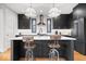 Stylish kitchen features dark cabinets, white countertops, stainless steel appliances, and island seating at 2026 Alvord St, Indianapolis, IN 46202