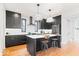 Modern kitchen boasts dark cabinets, white countertops, stainless steel appliances, and stylish pendant lighting at 2026 Alvord St, Indianapolis, IN 46202