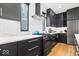 Well-equipped kitchen with dark cabinets, stainless steel appliances, white countertops, and modern backsplash at 2026 Alvord St, Indianapolis, IN 46202