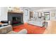 Comfortable living room featuring a tiled fireplace and seamless flow into the dining area at 2026 Alvord St, Indianapolis, IN 46202