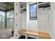 Functional mudroom with built-in bench seating, storage cubbies, and a view to the outdoor patio at 2026 Alvord St, Indianapolis, IN 46202