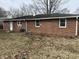 The backyard of this house is a spacious and private area with a well-maintained lawn and mature trees at 2032 Costello Dr, Anderson, IN 46011