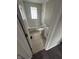 The renovated bathroom features a shower-tub combination, modern tile floors and neutral paint at 2032 Costello Dr, Anderson, IN 46011