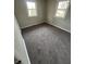 Comfortable bedroom featuring neutral carpeting and two windows for natural light at 2032 Costello Dr, Anderson, IN 46011