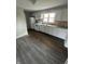 The kitchen features modern cabinets, and a clean backsplash, perfect for cooking and entertaining at 2032 Costello Dr, Anderson, IN 46011