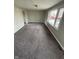 Bright living room with large windows and neutral carpet at 2032 Costello Dr, Anderson, IN 46011