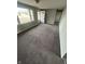 Open living room featuring new carpet, fresh paint, and ample natural light at 2032 Costello Dr, Anderson, IN 46011