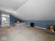 This is an attic with an accent wall and a small bed at 208 S Conger St, , IN 47272