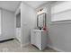 A bathroom with a white vanity, a black faucet and a small window on the right at 208 S Conger St, , IN 47272