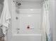 A white bathtub shower combination with white walls and a shower caddy at 208 S Conger St, , IN 47272