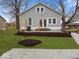 Inviting home exterior with fresh landscaping, a gravel driveway, and a well-manicured lawn at 208 S Conger St, , IN 47272
