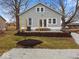 Inviting home exterior with fresh landscaping, a gravel driveway, and a well-manicured lawn at 208 S Conger St, , IN 47272