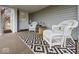 Inviting front porch featuring comfortable wicker seating and stylish outdoor rug at 208 S Conger St, , IN 47272