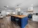 Modern kitchen with a large island, butcher block countertop, and stainless steel appliances at 208 S Conger St, , IN 47272
