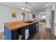 Modern kitchen with a large island, butcher block countertop, and stainless steel appliances at 208 S Conger St, , IN 47272