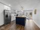 Spacious kitchen featuring an island, stainless steel refrigerator, and white cabinets at 208 S Conger St, , IN 47272