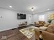 Bright living room with hardwood floors, leather sofas, and modern decor at 208 S Conger St, , IN 47272