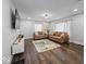 Bright living room with hardwood floors, leather sofas, and modern decor at 208 S Conger St, , IN 47272